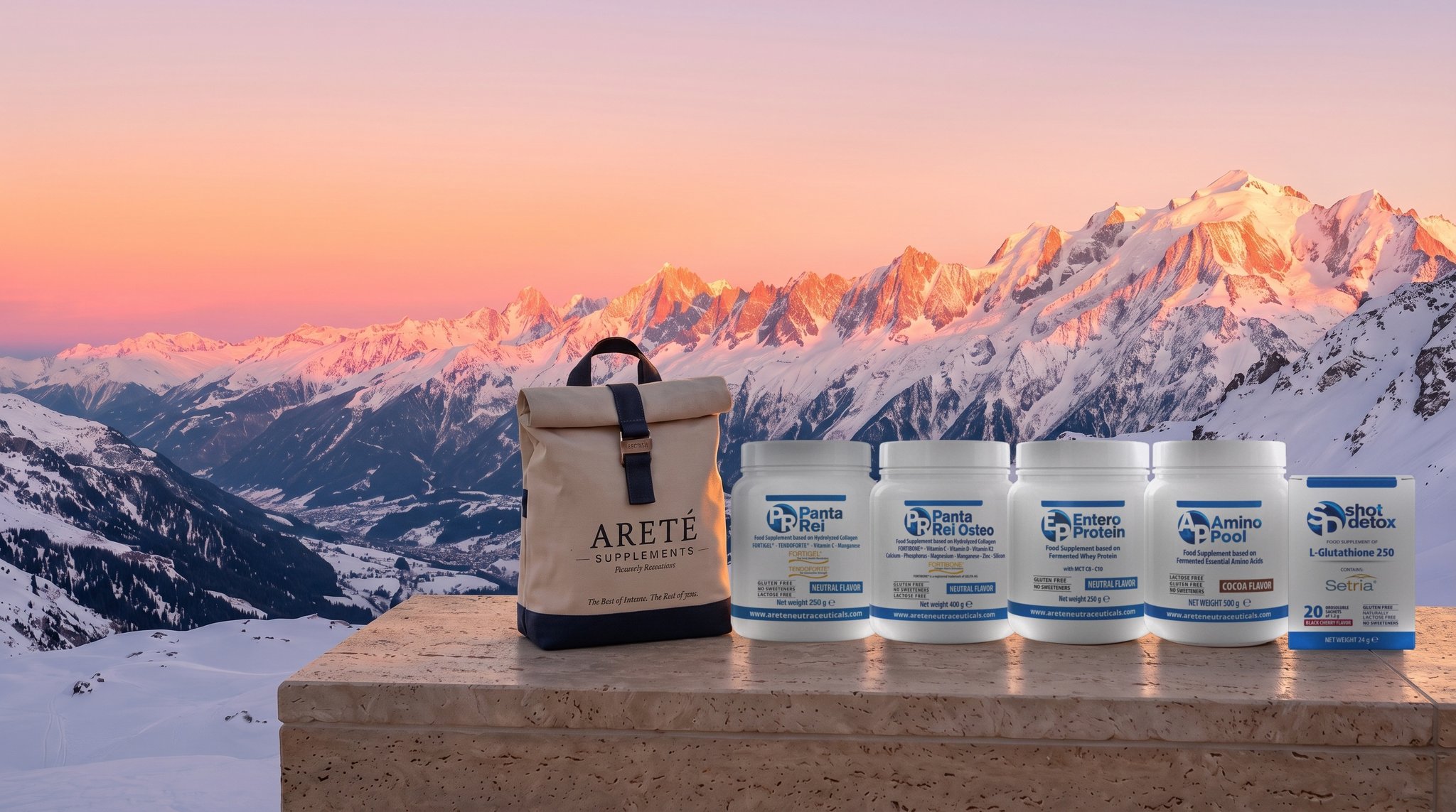 Areté bag and the formulations on a stone ledge, snowy peaks at sunset